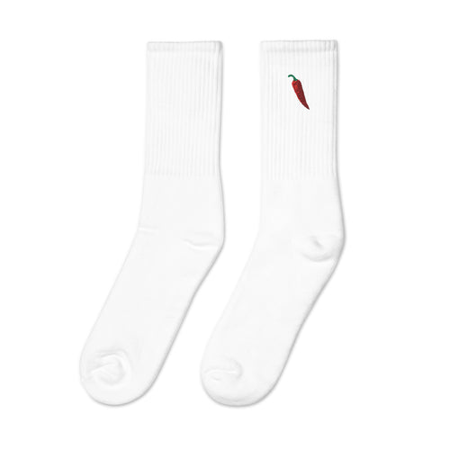 A pair of white socks with a red chili pepper design