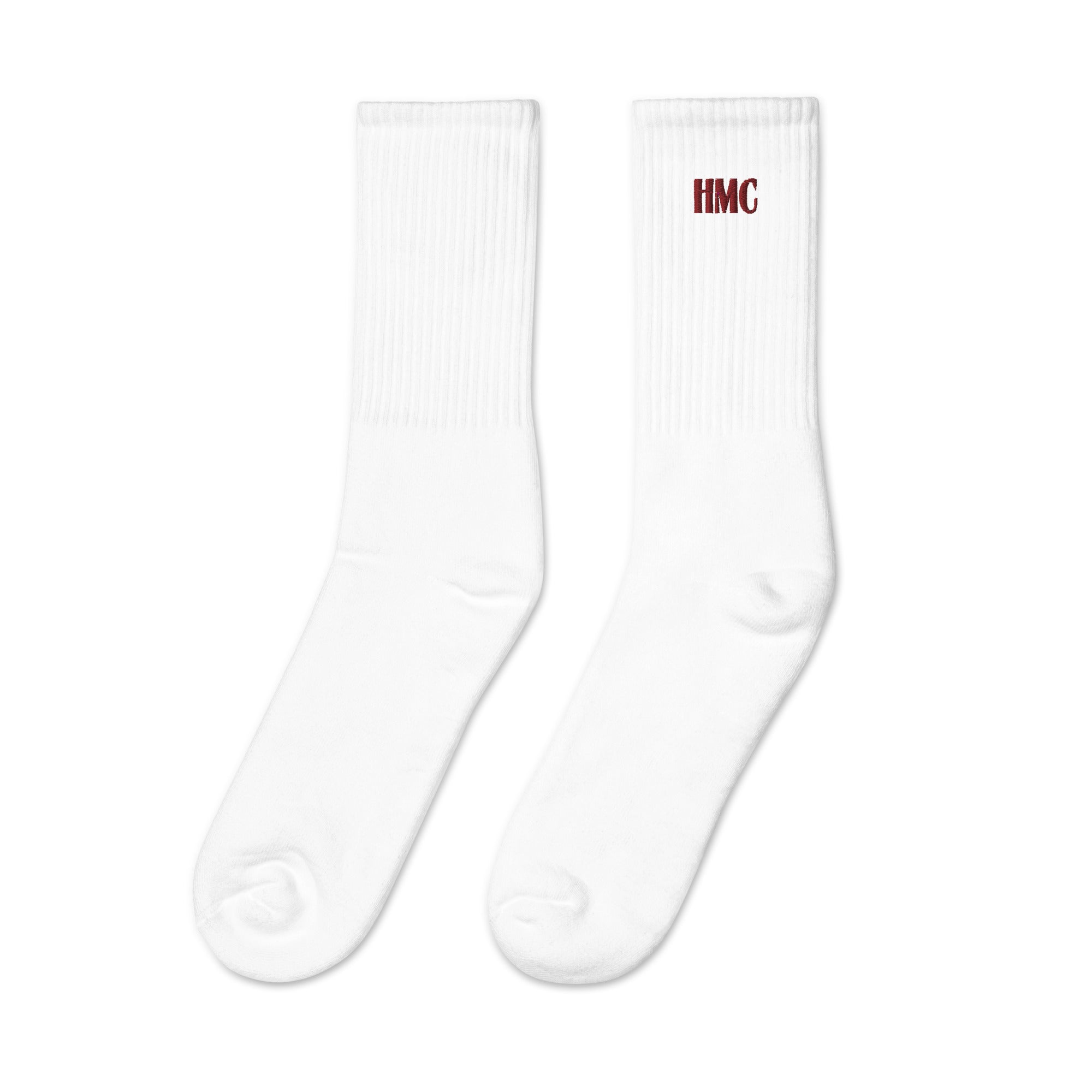 Mockup of white crew socks with burgundy embroidery logo HMC