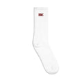 Left facing mockup of white crew socks with burgundy embroidery logo HMC