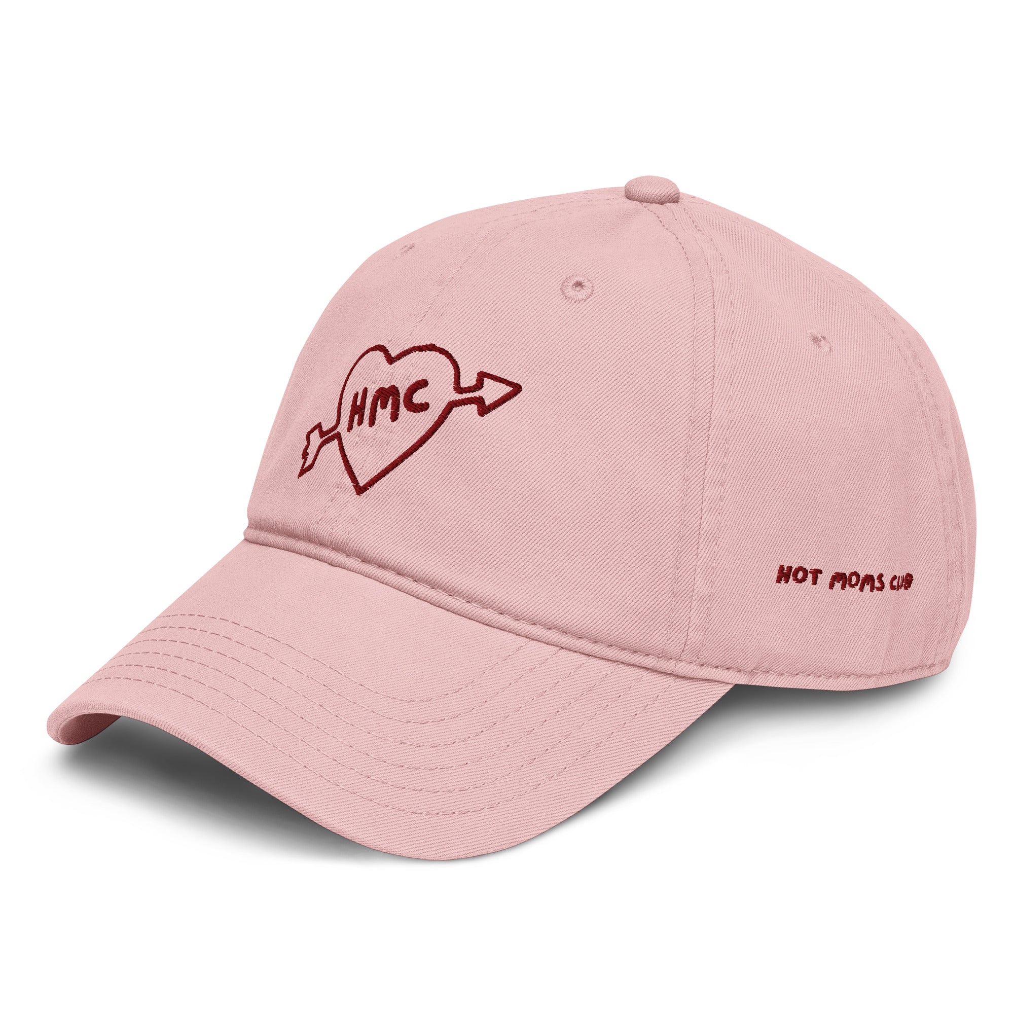 Right side view of a pink baseball cap with 'HMC' inside a heart with an arrow through it embroidered in burgundy with HOT MOMS CLUB embroidered on the side