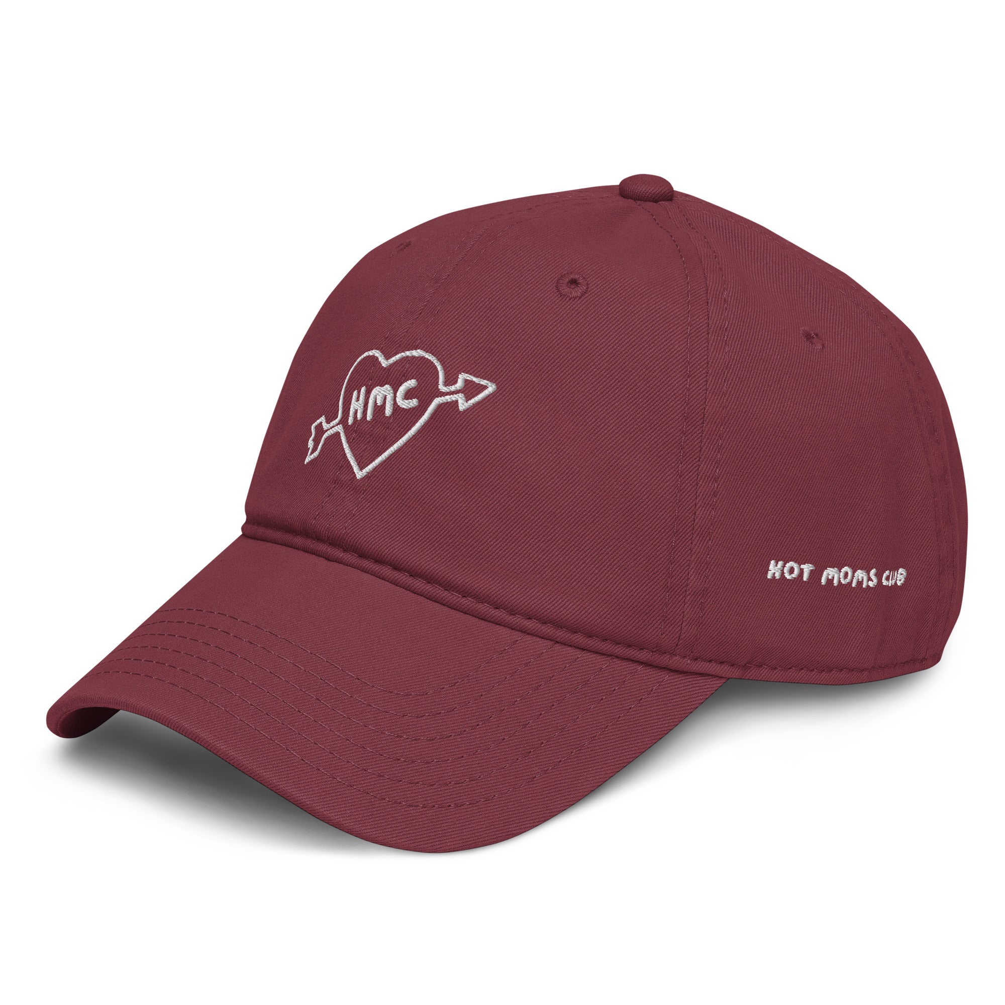 Right side view of a burgundy baseball cap with "HMC" inside of a heart with an arrow through it embroidered in white thread and HOT MOMS CLUB embroidered on the sid